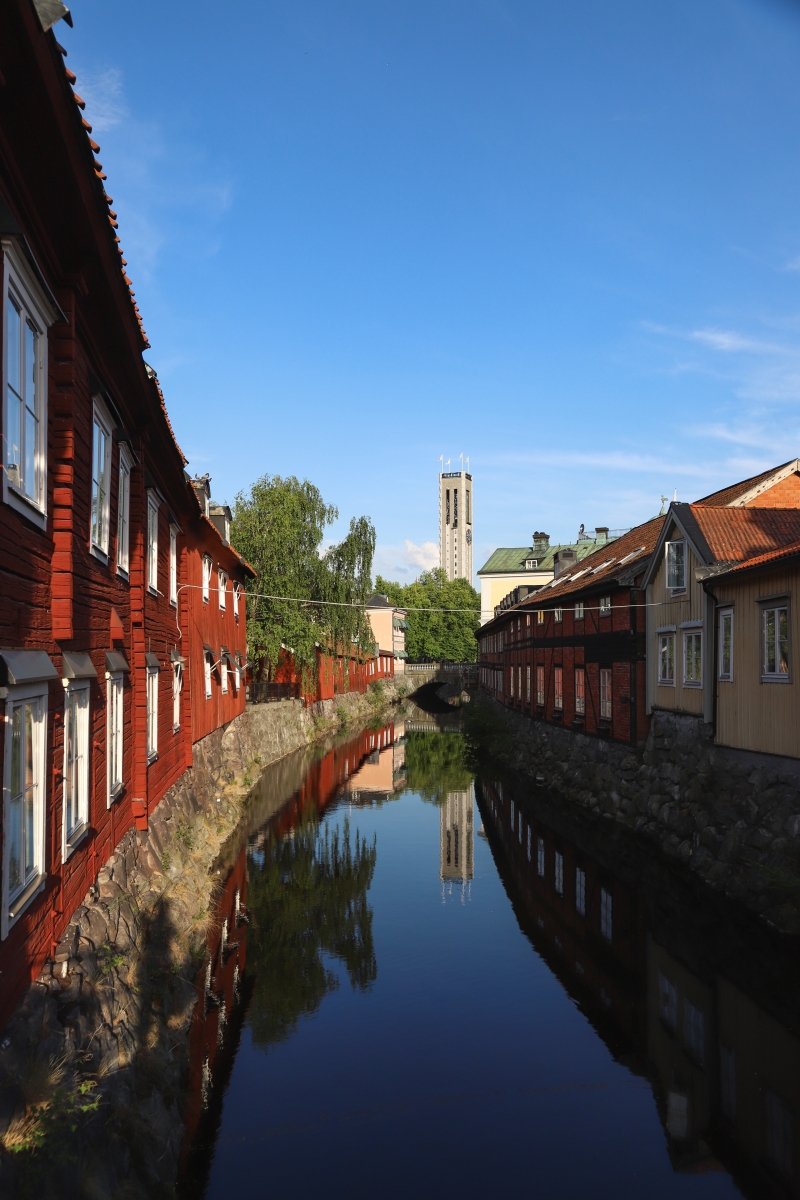 Svartån sett från en bro, med röda äldre byggnader längs sidorna.